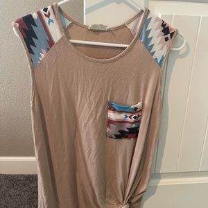 Women’s tank top. Longer torso top. Can be tied in side knot. Aztec design